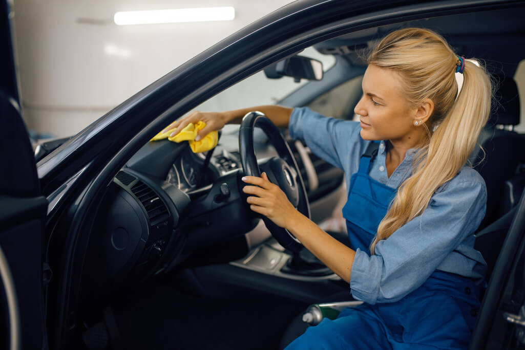 woman using car detailing tools 